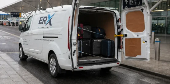 Suitcases secured inside a van for airport luggage delivery